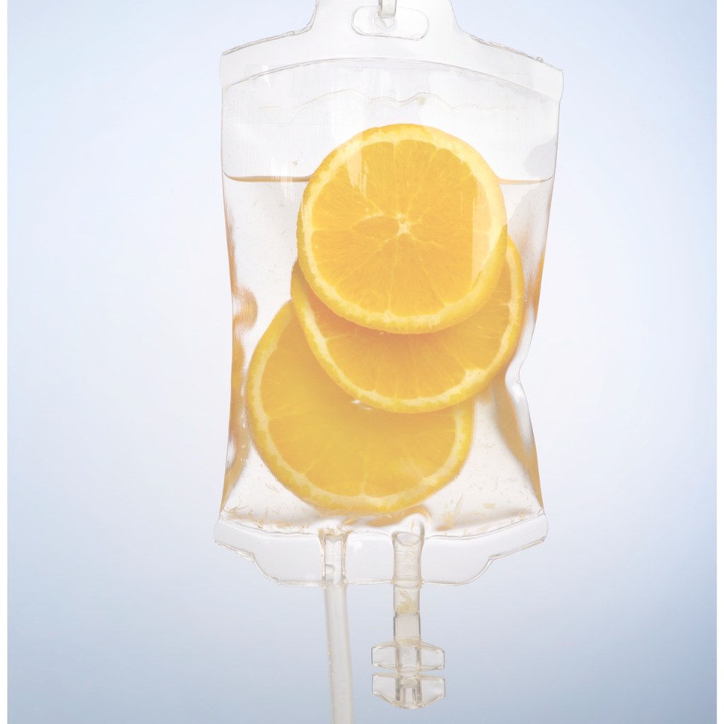 Glass IV bag of golden vitamin C solution